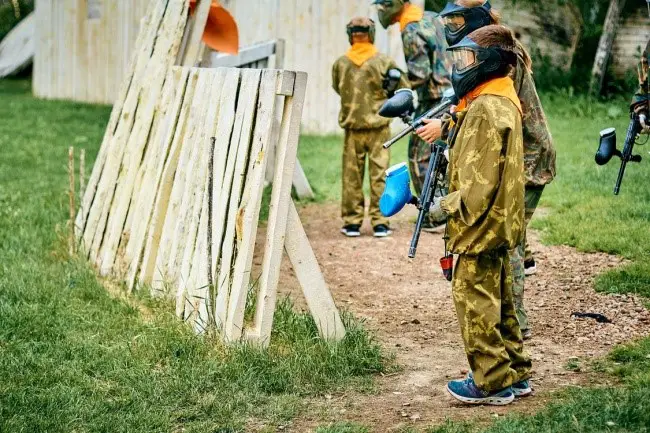 Kids playing paintball in camouflage attire