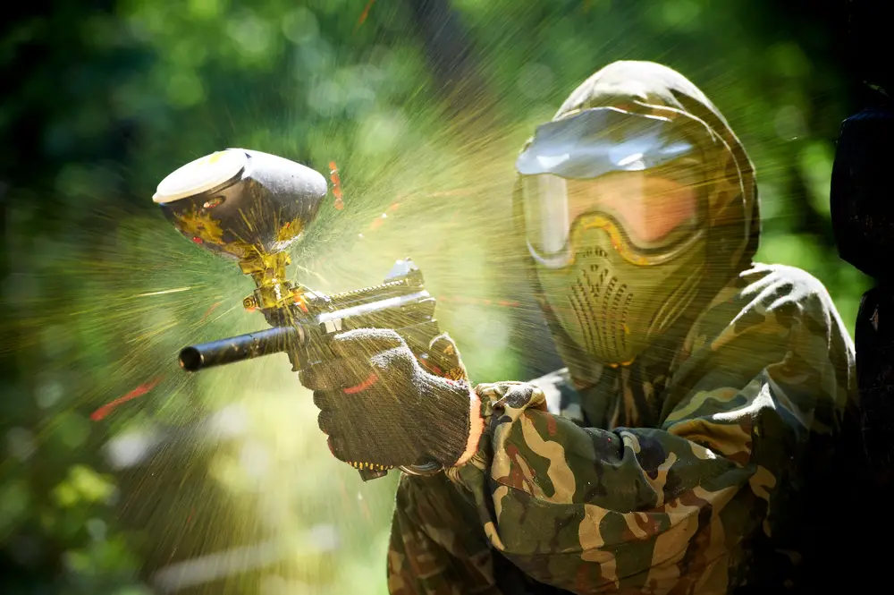 paintball sport player playing paintball wearing protective mask