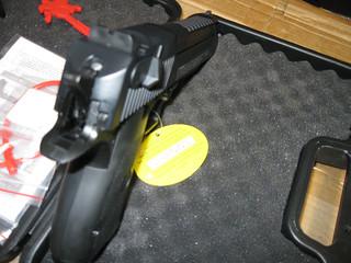 A close-up view of the firing mechanism in a mechanical paintball marker, showing how the trigger directly actuates the sear and bolt to release air and propel the paintball.