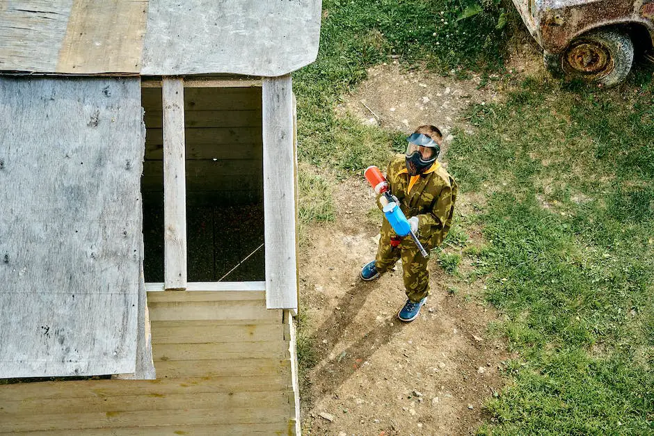 A person cleaning a paintball gun