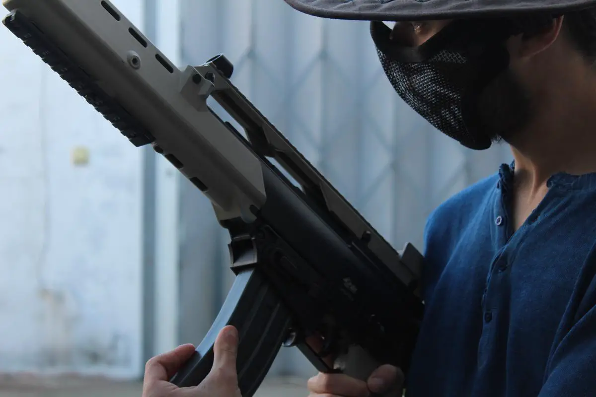 Image of a person in paintball gear holding a paintball gun